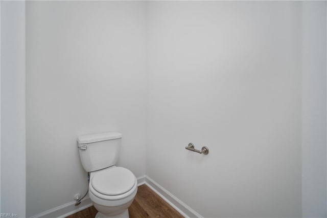 bathroom featuring hardwood / wood-style flooring and toilet