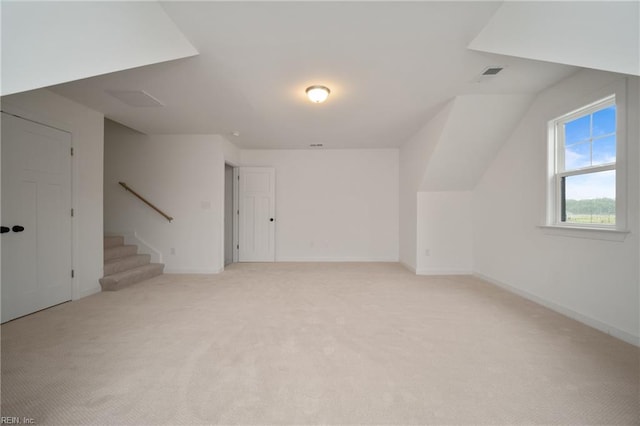 bonus room with light colored carpet