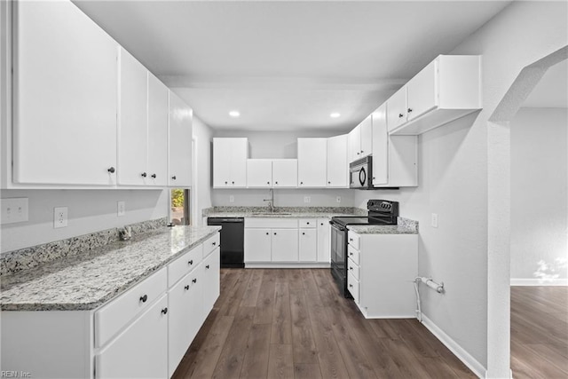 kitchen featuring white cabinets, dark hardwood / wood-style flooring, black appliances, and sink