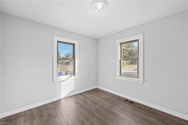 spare room featuring dark hardwood / wood-style flooring