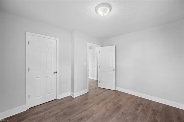 unfurnished bedroom featuring hardwood / wood-style flooring and a closet