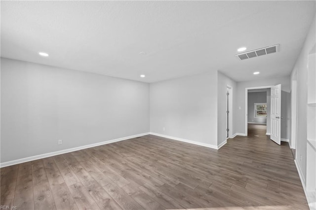 empty room with dark wood-type flooring