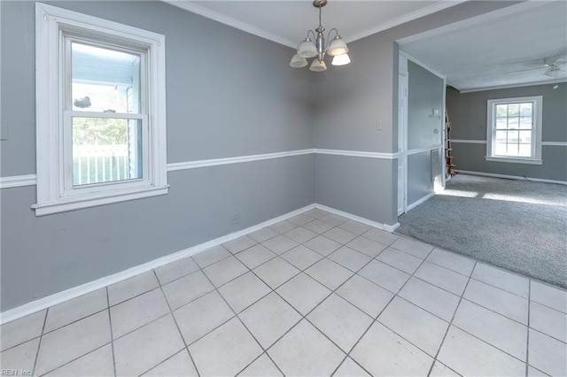 tiled empty room with ornamental molding and ceiling fan with notable chandelier