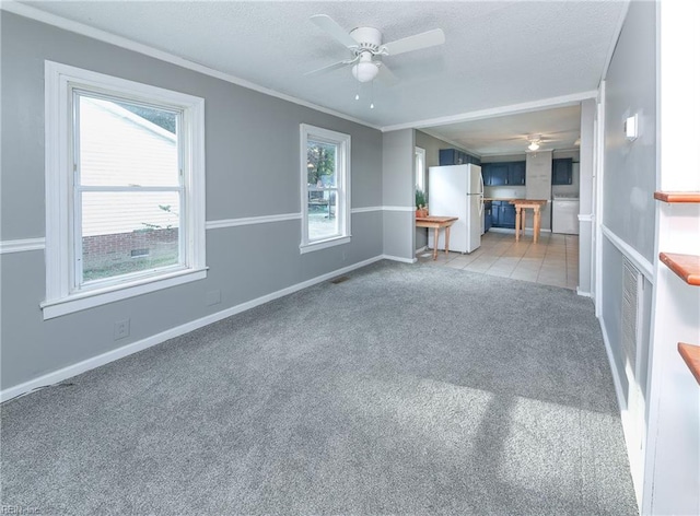 unfurnished living room with ornamental molding, carpet, a healthy amount of sunlight, and ceiling fan