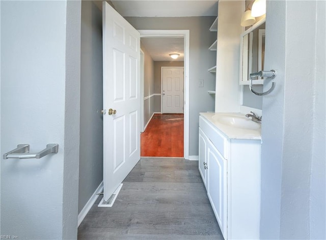 bathroom with hardwood / wood-style floors and vanity