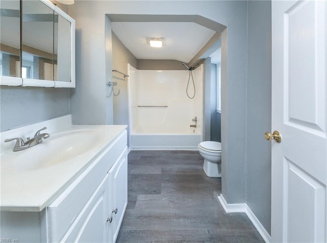 full bathroom with shower / bath combination, wood-type flooring, toilet, and vanity