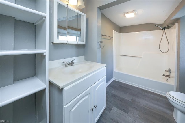 full bathroom with hardwood / wood-style floors, vanity, toilet, and bathtub / shower combination