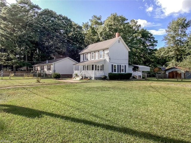 back of house with a lawn