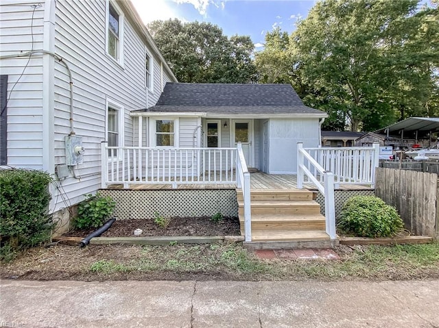 view of front of property with a carport and a deck