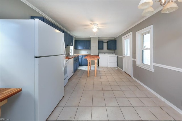 kitchen with crown molding, white refrigerator, blue cabinets, independent washer and dryer, and ceiling fan with notable chandelier