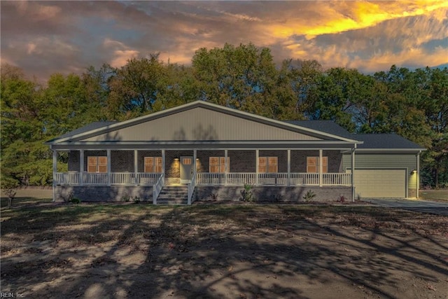 view of front of house featuring a porch and a garage