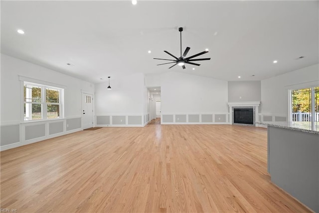 unfurnished living room with plenty of natural light, ceiling fan, and light hardwood / wood-style flooring