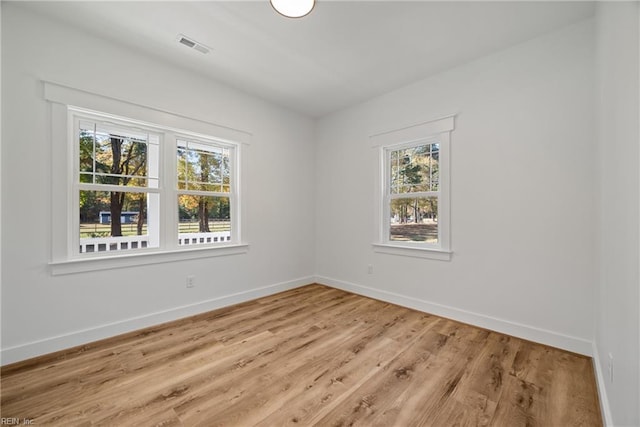 spare room with light hardwood / wood-style flooring