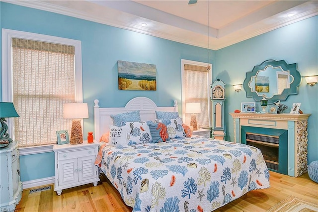 bedroom featuring ornamental molding and light hardwood / wood-style floors