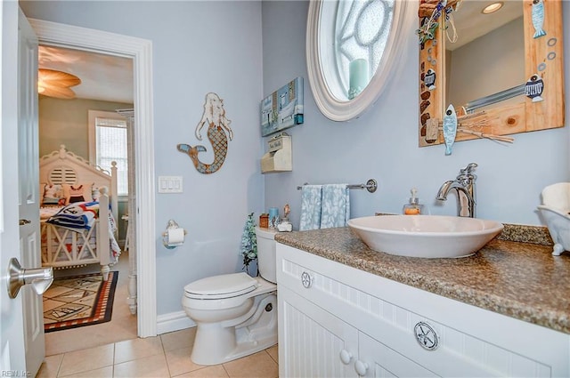 bathroom featuring toilet, vanity, and tile patterned floors