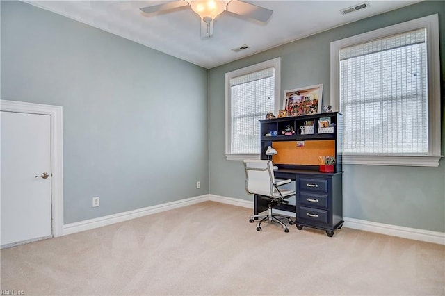 carpeted office space with ceiling fan