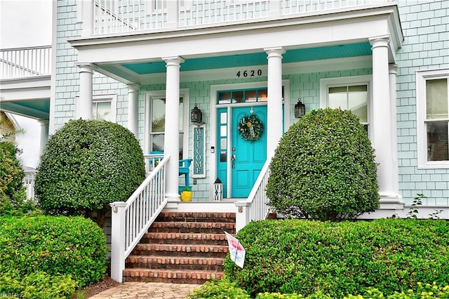 view of exterior entry featuring covered porch