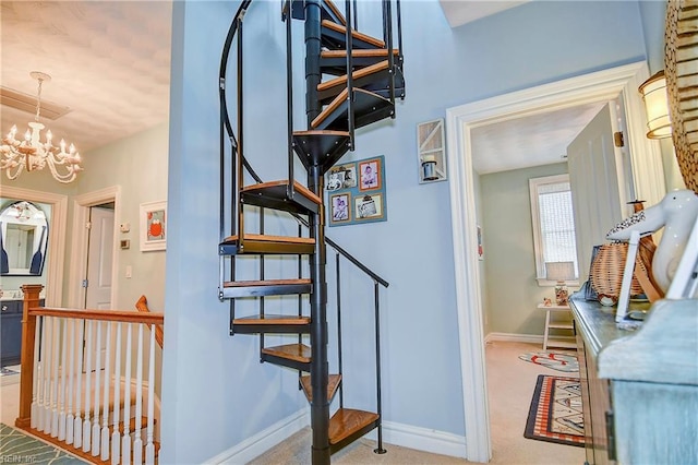 staircase featuring a chandelier and carpet flooring