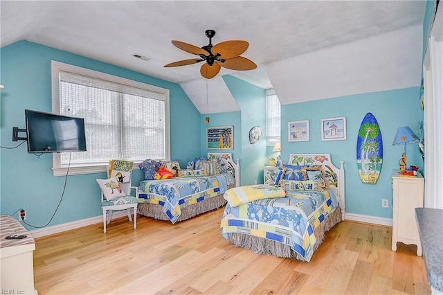 bedroom featuring ceiling fan, light wood-type flooring, and vaulted ceiling