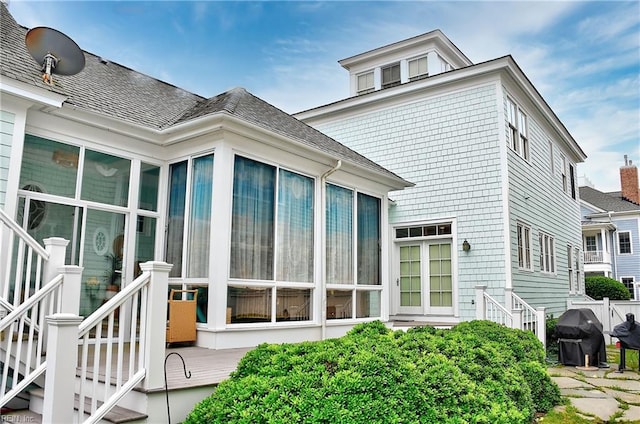 rear view of house featuring a sunroom