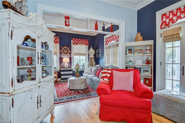 interior space with a healthy amount of sunlight, light hardwood / wood-style flooring, and ornamental molding