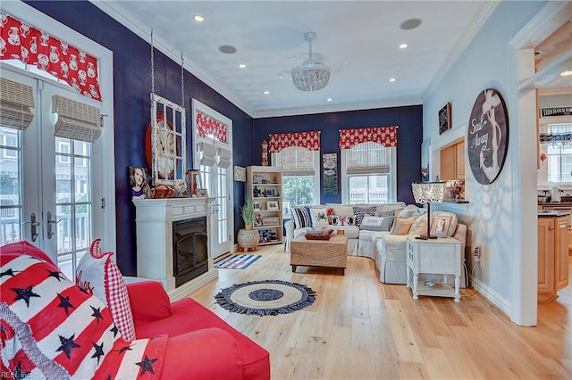 living room featuring french doors, light wood-type flooring, and crown molding