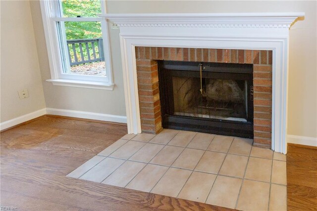 interior details with a fireplace and wood-type flooring