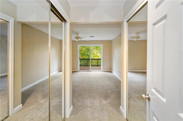 hallway featuring light carpet