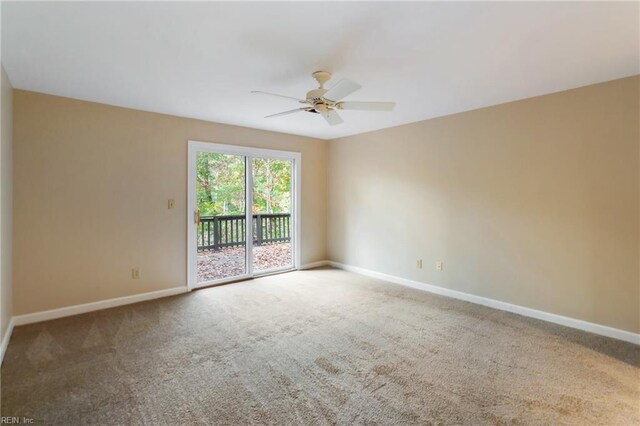 carpeted spare room featuring ceiling fan