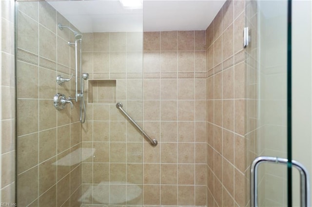 bathroom featuring a shower with door