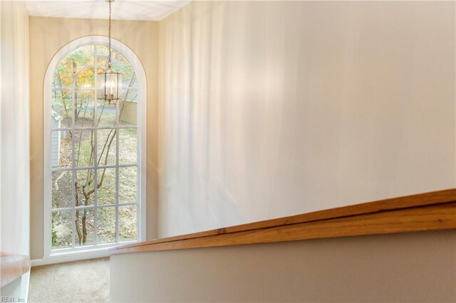 details featuring carpet floors and a notable chandelier