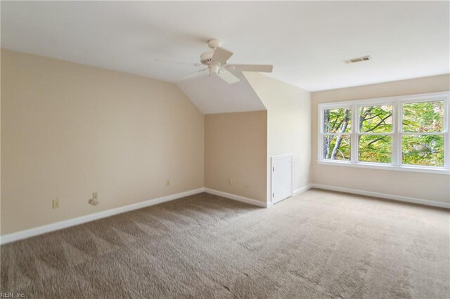 additional living space with carpet floors, lofted ceiling, and ceiling fan