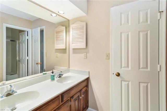 bathroom featuring vanity and a shower with shower door