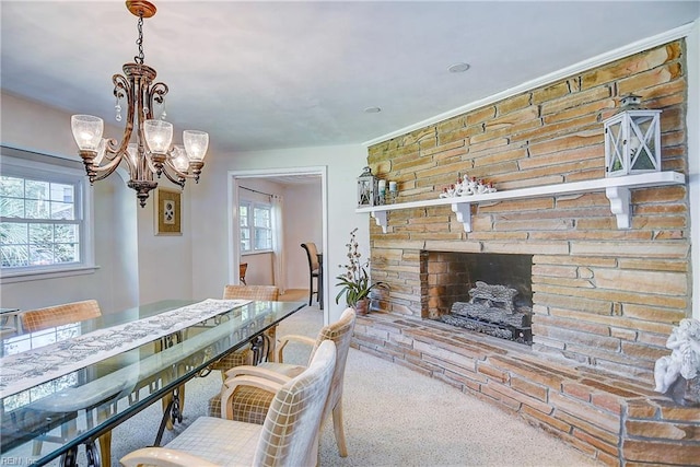 carpeted dining area with a stone fireplace