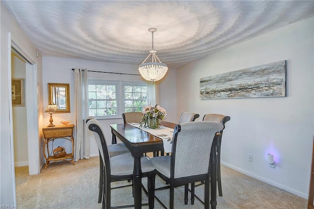 dining area featuring an inviting chandelier and light colored carpet