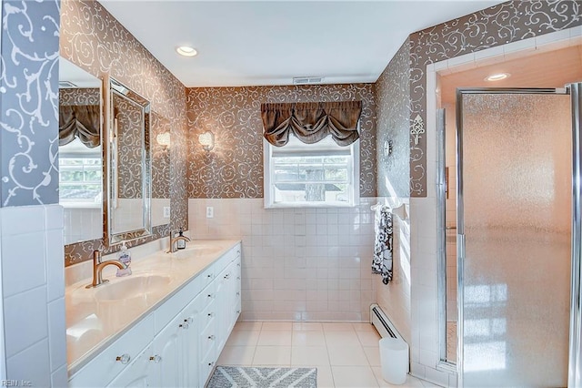 bathroom with tile walls, a baseboard radiator, plenty of natural light, and tile patterned floors