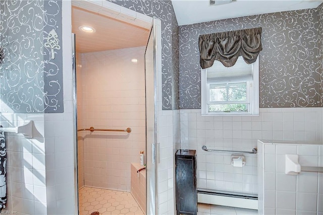 bathroom with tile walls, tile patterned flooring, and baseboard heating