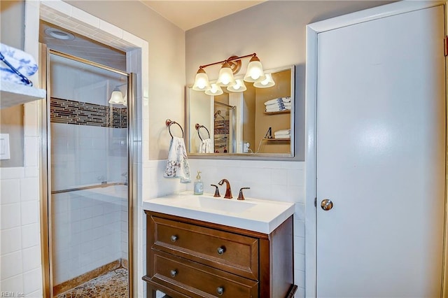 bathroom with walk in shower, vanity, and tile walls