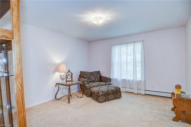 living area with a baseboard radiator and light colored carpet