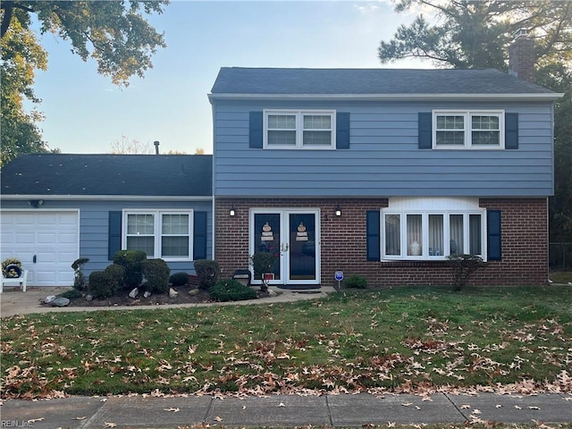 front of property with a garage and a front yard