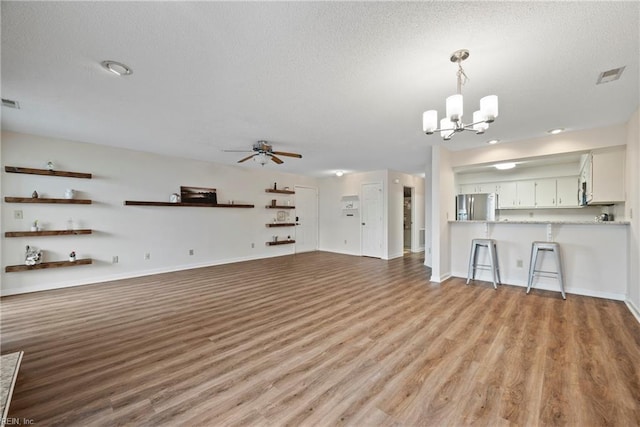 157 Atlantic Ave Unit B2, Hampton, VA 23664 - unfurnished living room with a chandelier, wood finished floors, a textured ceiling, ceiling fan, and baseboards
