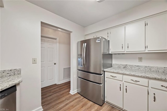 157 Atlantic Ave Unit B2, Hampton, VA 23664 - kitchen featuring stainless steel appliances, light wood-style floors, white cabinets, and baseboards