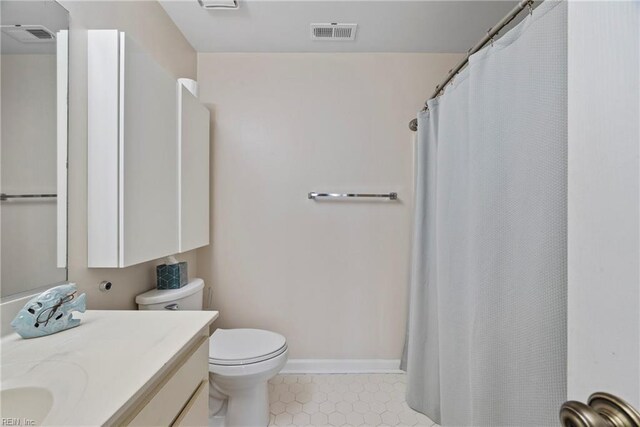157 Atlantic Ave Unit B2, Hampton, VA 23664 - bathroom featuring toilet, vanity, tile patterned floors, baseboards, and a shower with shower curtain