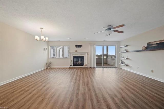 157 Atlantic Ave Unit B2, Hampton, VA 23664 - unfurnished living room featuring a textured ceiling, baseboards, a chandelier, a ceiling fan, and a glass covered fireplace