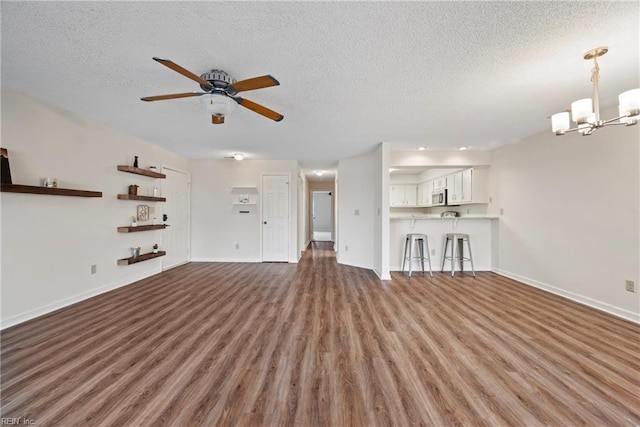 157 Atlantic Ave Unit B2, Hampton, VA 23664 - unfurnished living room with wood finished floors, a ceiling fan, a textured ceiling, a chandelier, and baseboards