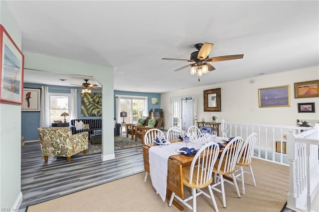 dining area with ceiling fan, plenty of natural light, and carpet flooring