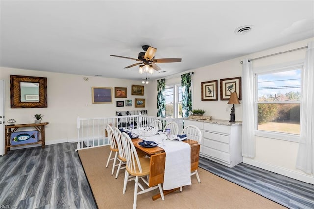 dining room with ceiling fan, hardwood / wood-style flooring, and a healthy amount of sunlight