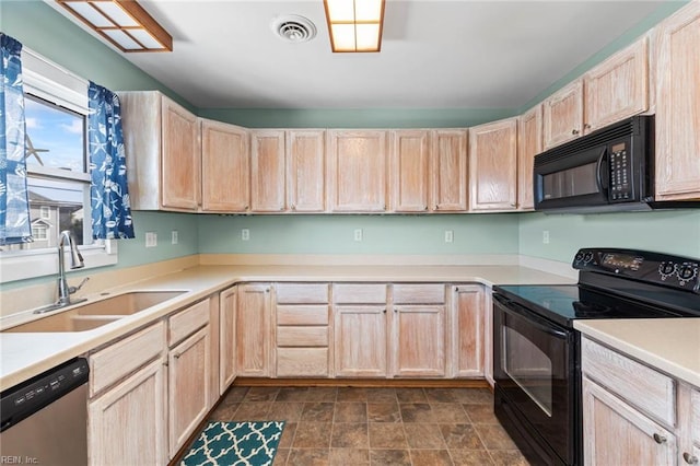 kitchen featuring light brown cabinetry, sink, and black appliances