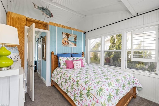 bedroom with wood walls, lofted ceiling with beams, and carpet floors