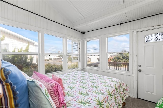 bedroom featuring vaulted ceiling with beams, carpet floors, and multiple windows